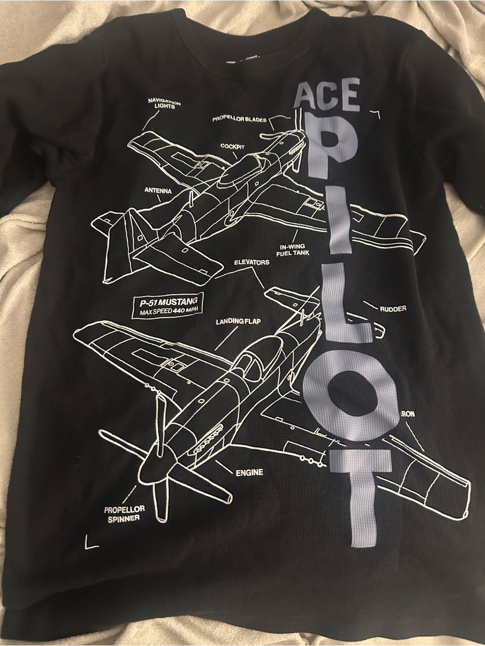 Place Black Tee with White Airplane Schematic and Gray 'ACE PILOT' Text